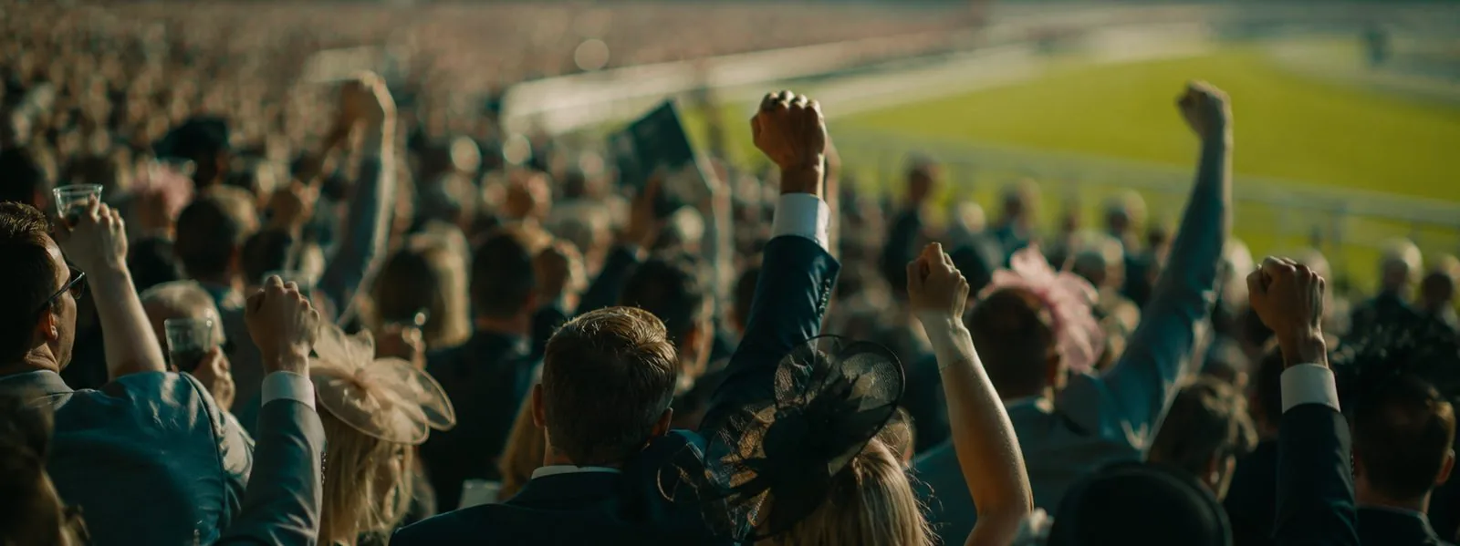A colourful, excited racecourse crowd on Ladies Day at a British racecourse